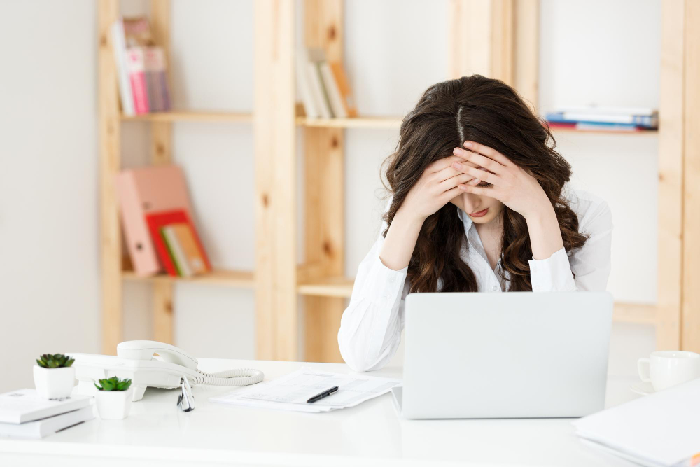 A business woman going through stress at work.