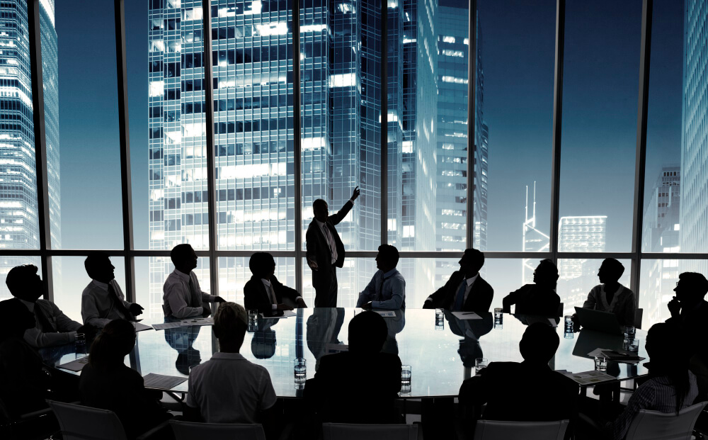 Business people in a board room meeting with a nice view of corporate buildings