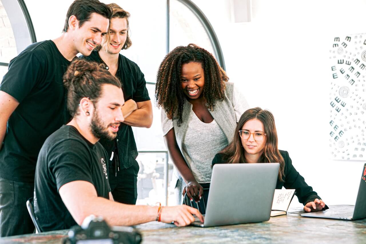 Work colleagues looking at a laptop in the office