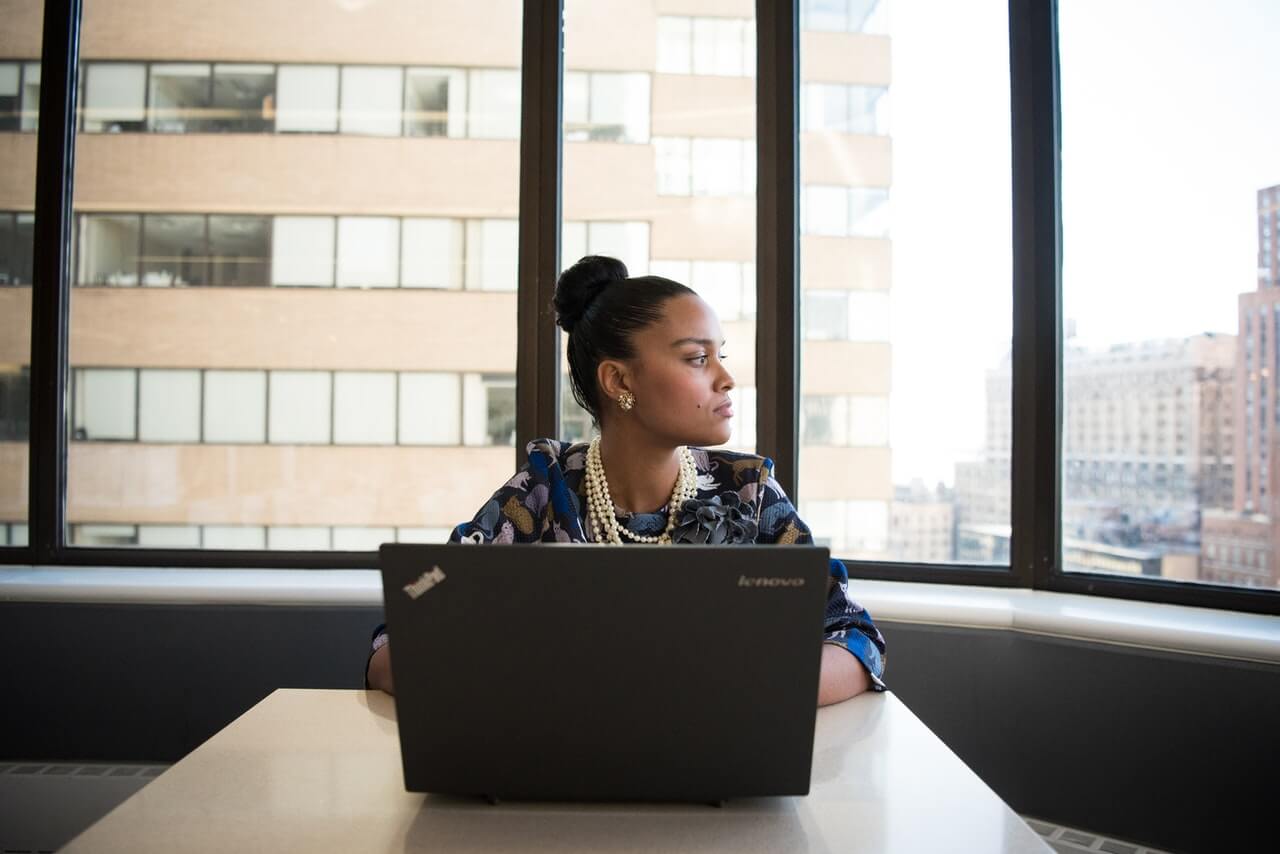 Businesswoman in office sitting in front of her laptop