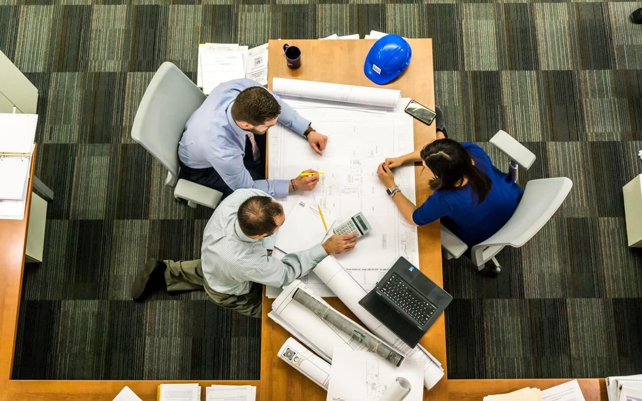 Work colleagues working on a design on a desk