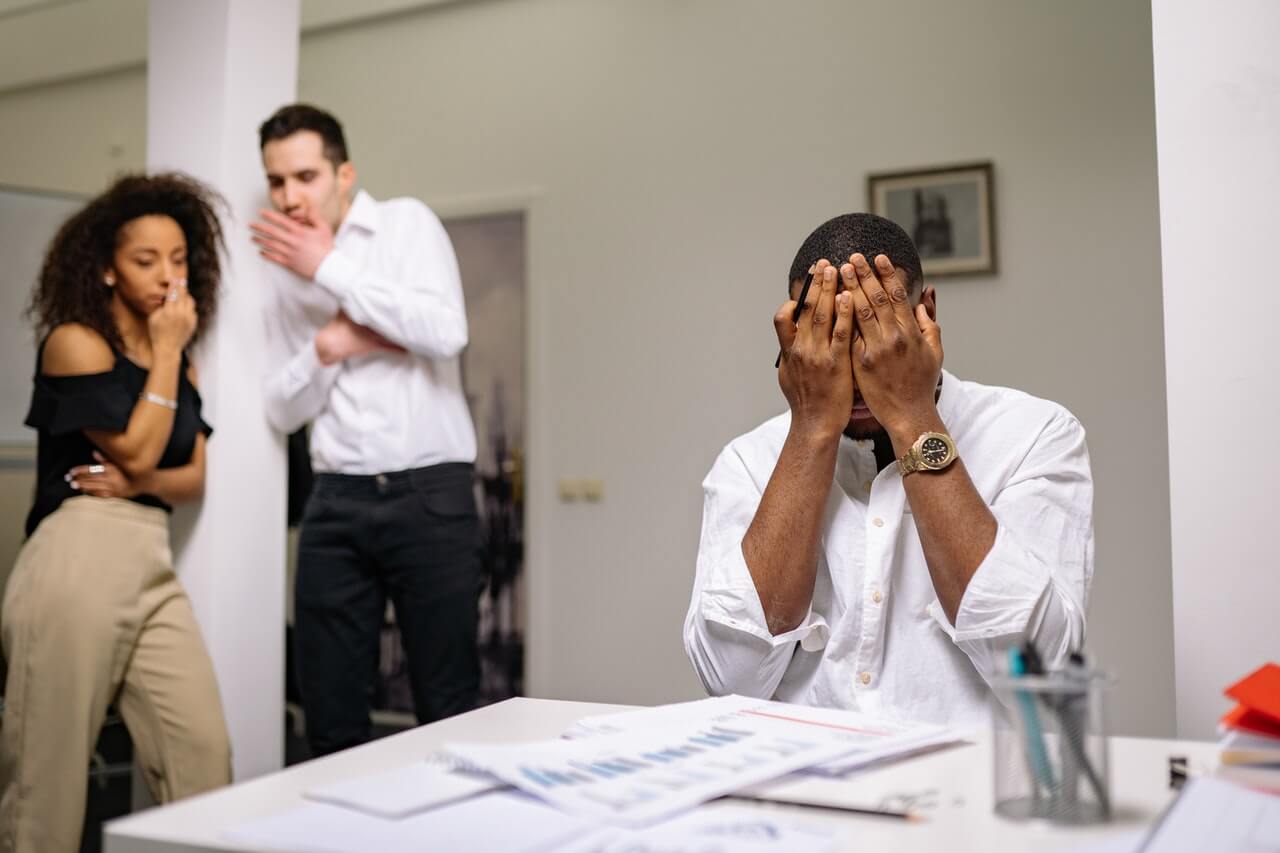 Businessman burying his face in his palms