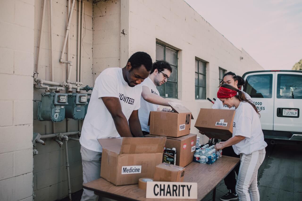 Volunteers sorting donations into the right boxes