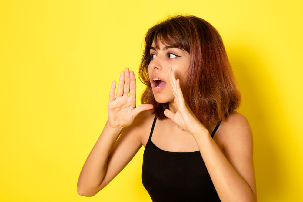 Young girl in a black shirt whispering