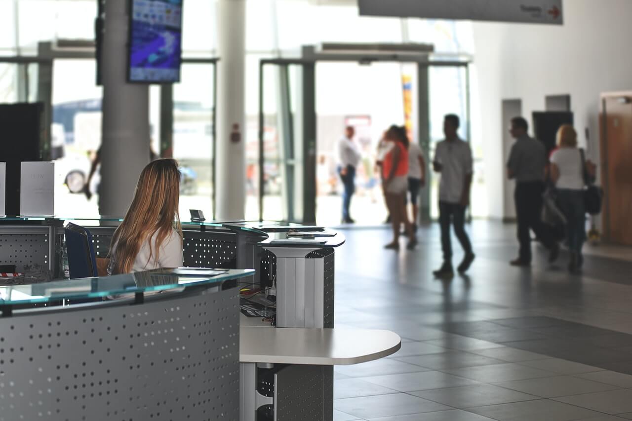 An office lobby with a lady behind the counter