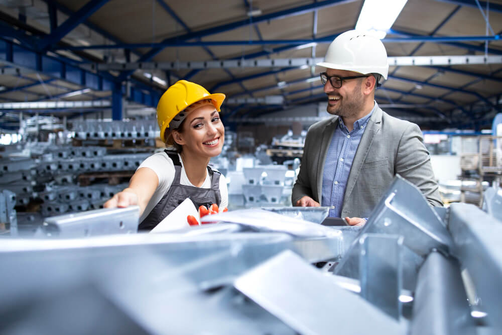 Factory workers with helmet smiling at work