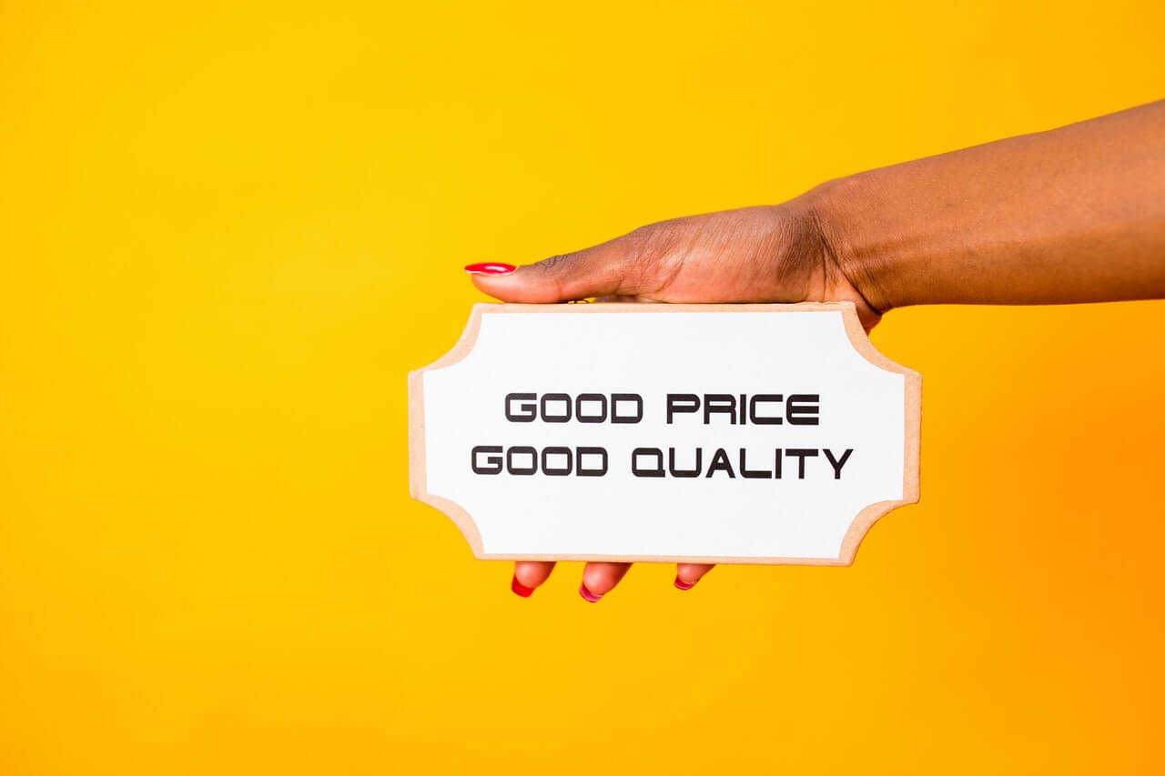 Hand holding a signage on a yellow background