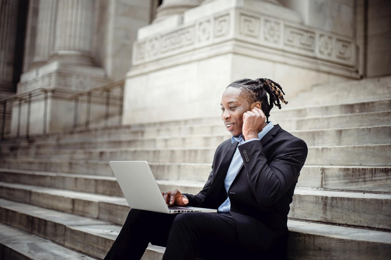 A salesman crafting a sales letter on their laptop