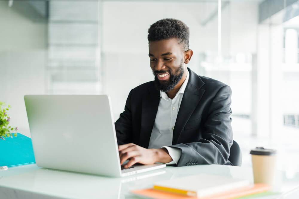 Young business professional reading a page on his laptop