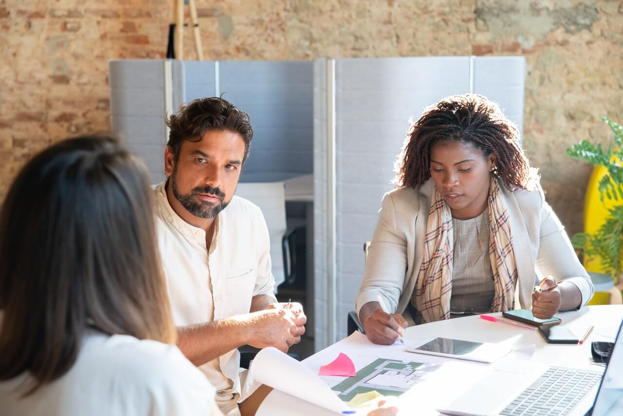 Business executives with their funder in a board room.