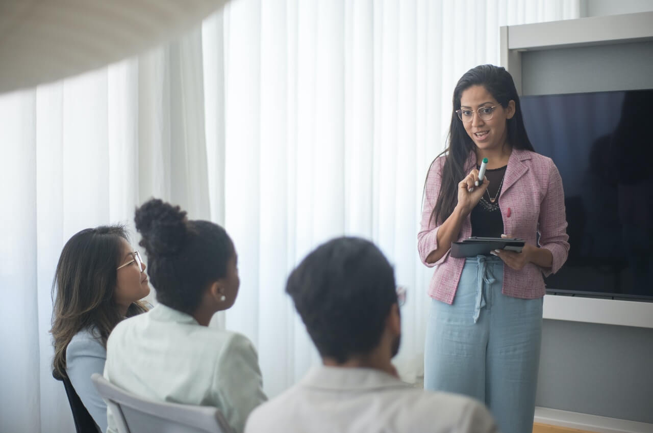 A-female-team-leader-communicating-the-team-goals-to-her-mates