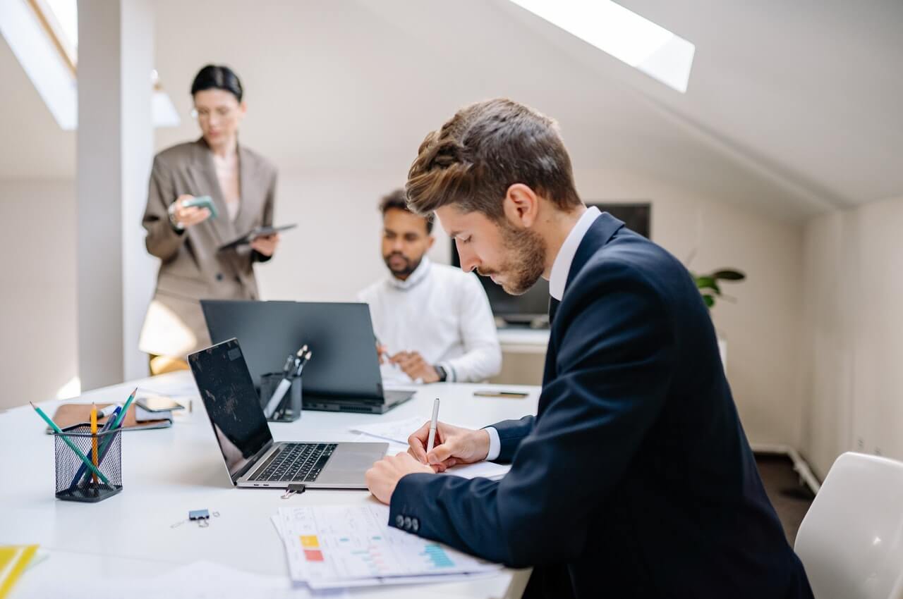 An-office-man-writing-on-a-paper-in-his-office