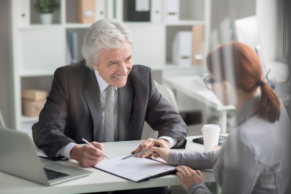 A woman with a banker opening a new bank account with one of the best banks in California