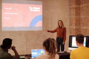 A woman presenting with projected slides