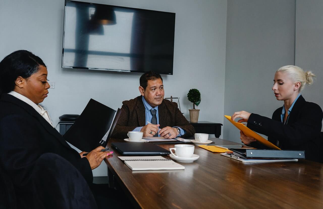 A-female-consultant-having-a-meeting-with-clients-in-an-office