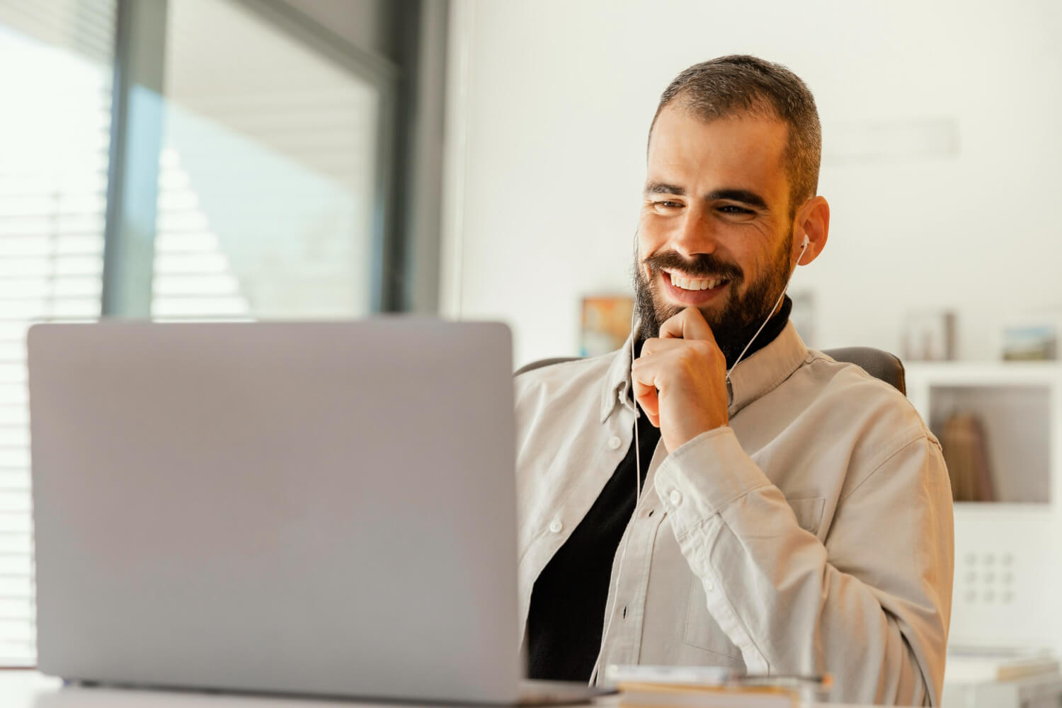 Businessman reading from his laptop while smiling