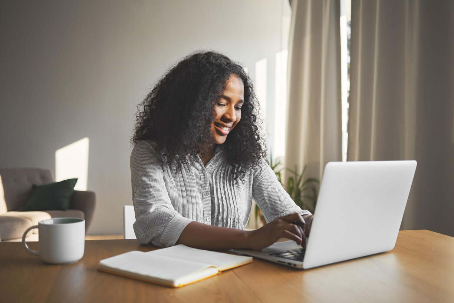 A lady working on a blog using her laptop