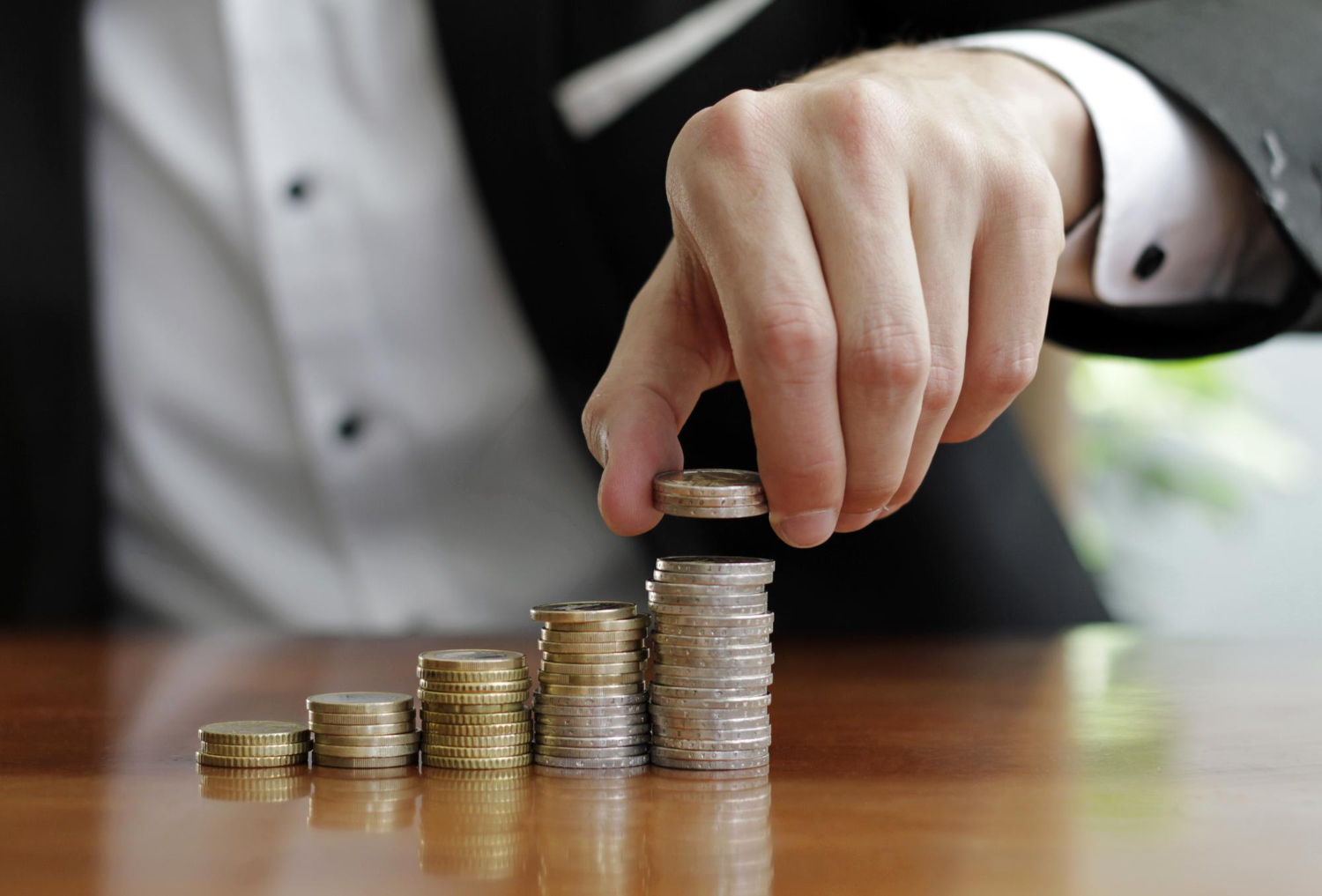 Businessman counting stack coins