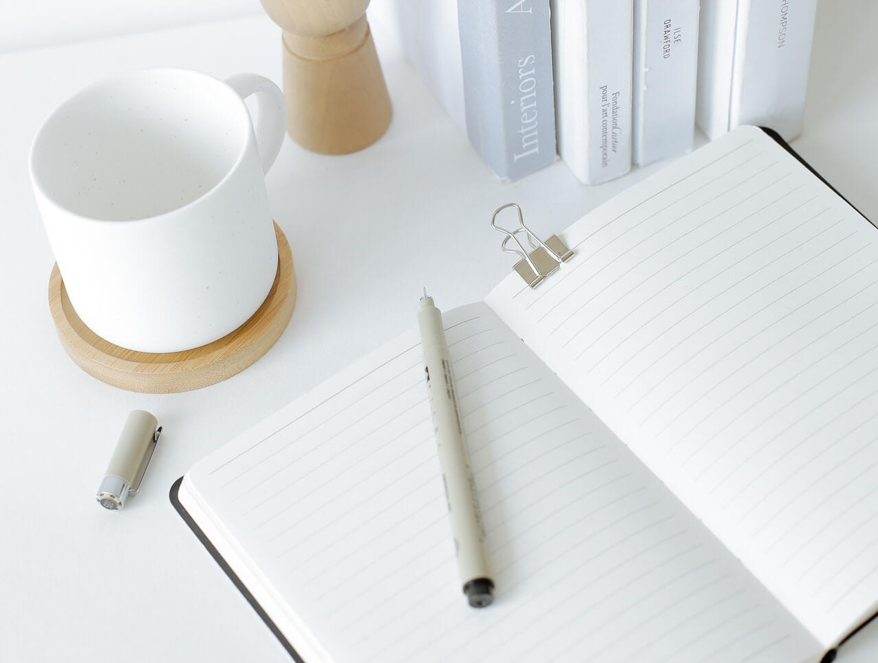 Notebook opened on desk near books