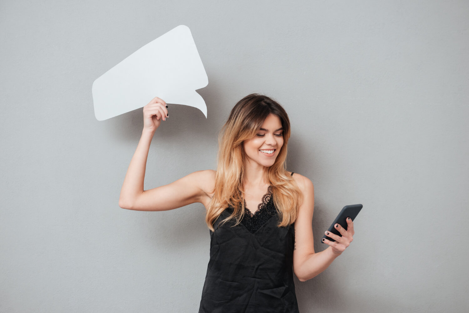 Smiling young woman using mobile phone