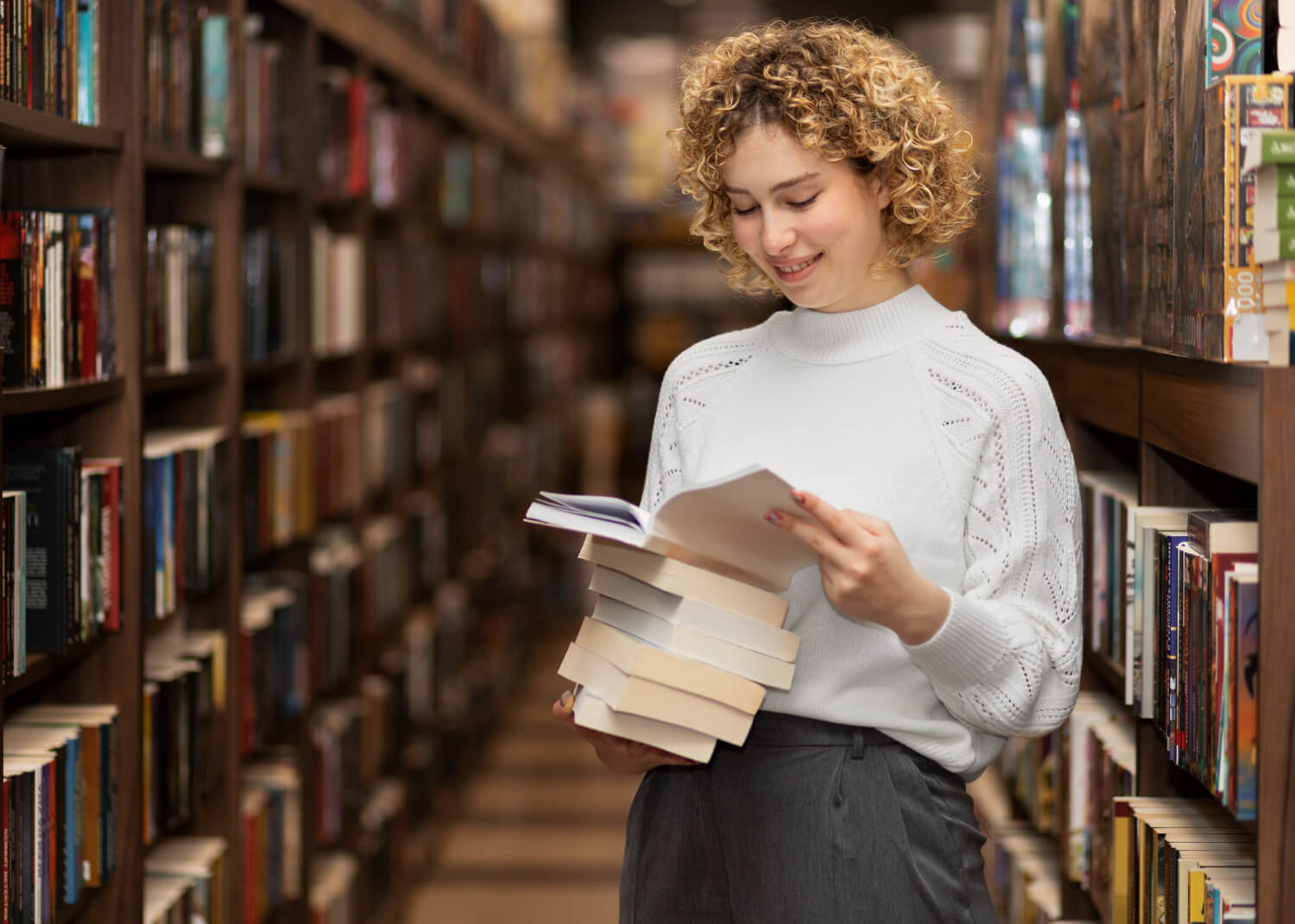 Young lady reading a book in a library