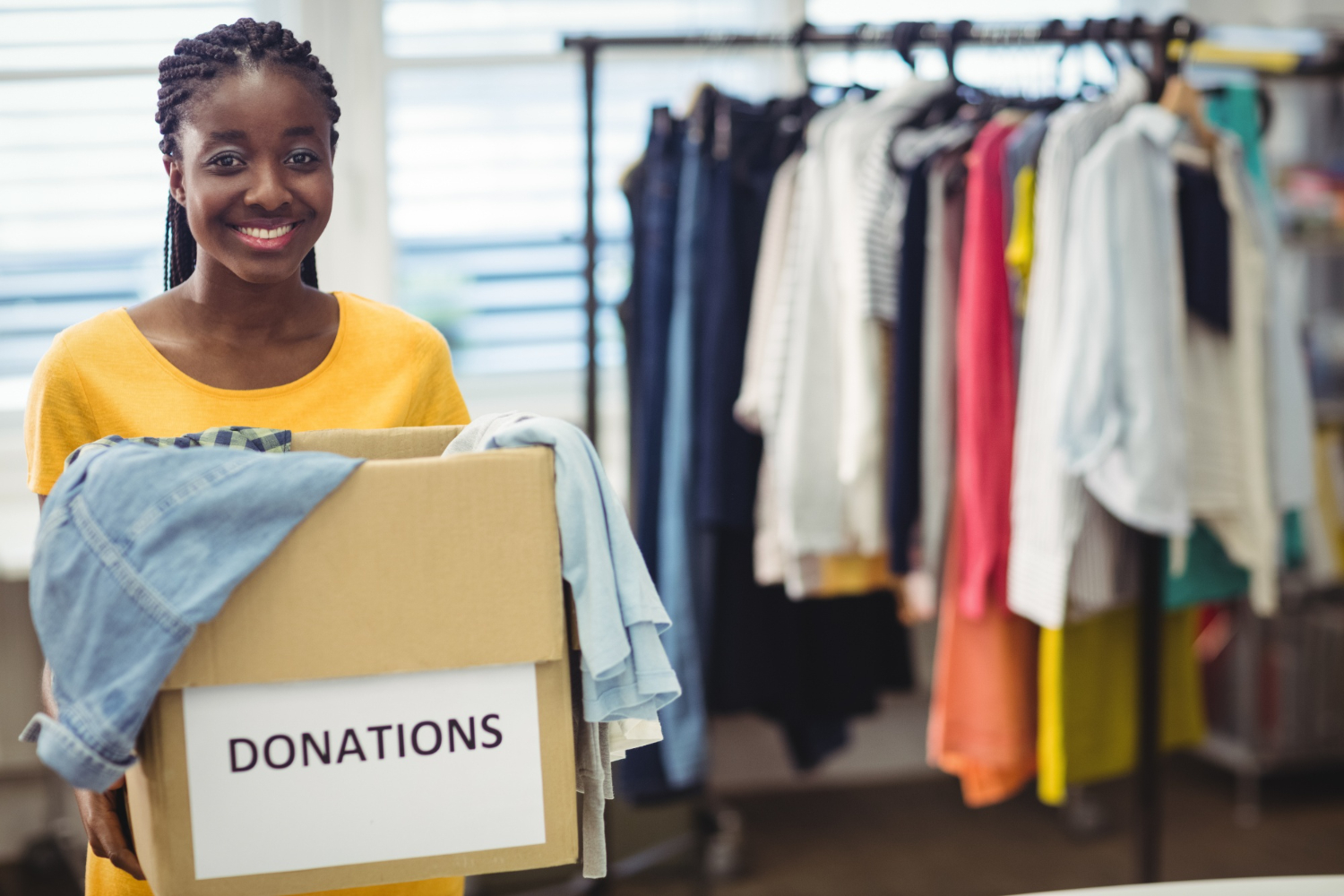 female-volunteer-holding-clothes-donation-box