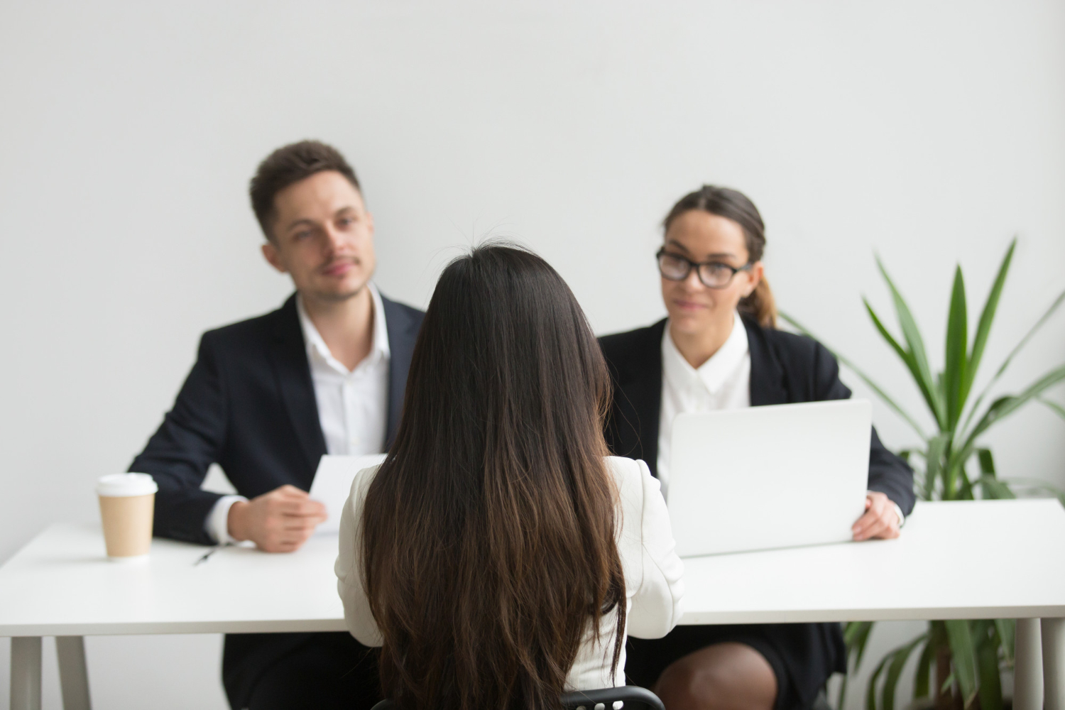 A-woman-interviewed-by-a-panel-in-an-office