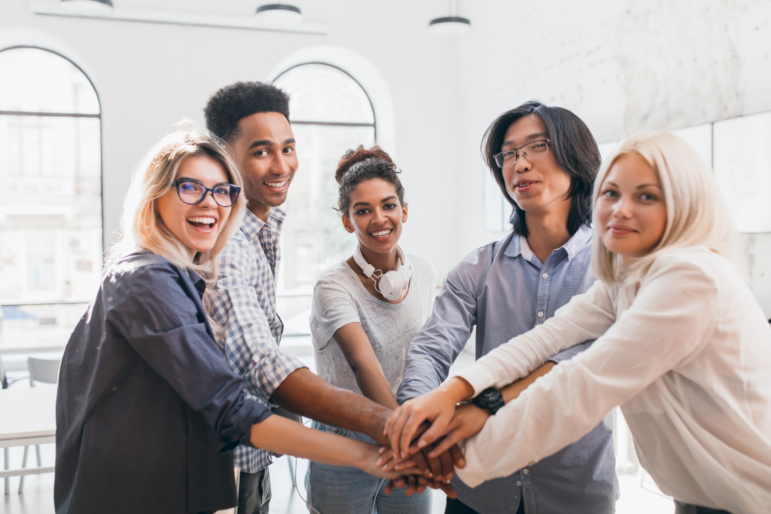 An-office-team-rejoicing-and-holding-hand-together.