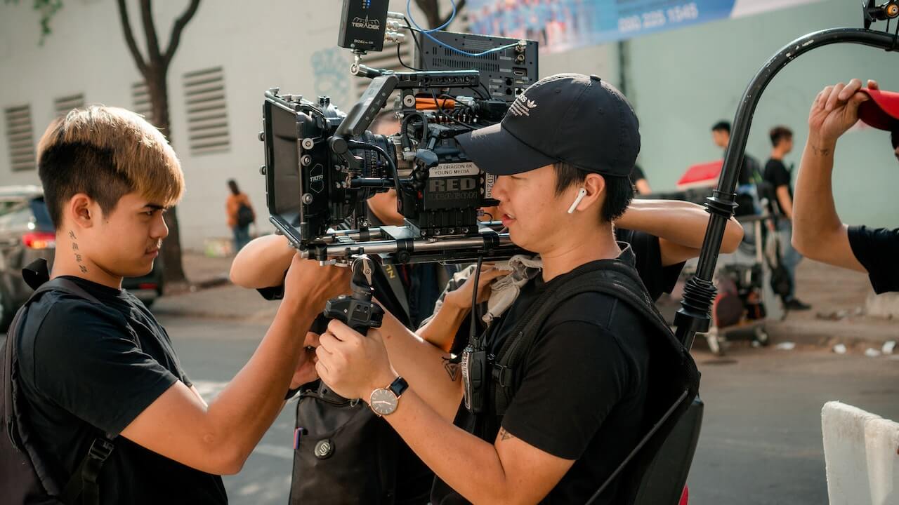 Men holding a camera for a TV interview