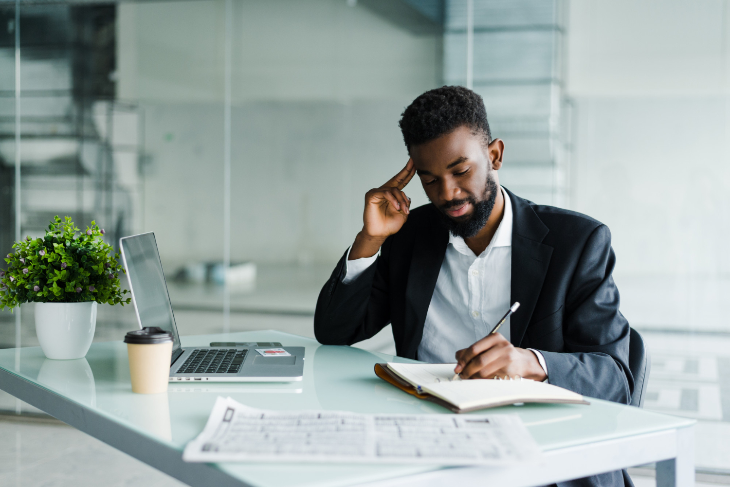 Businessman-working in an office writing on a note