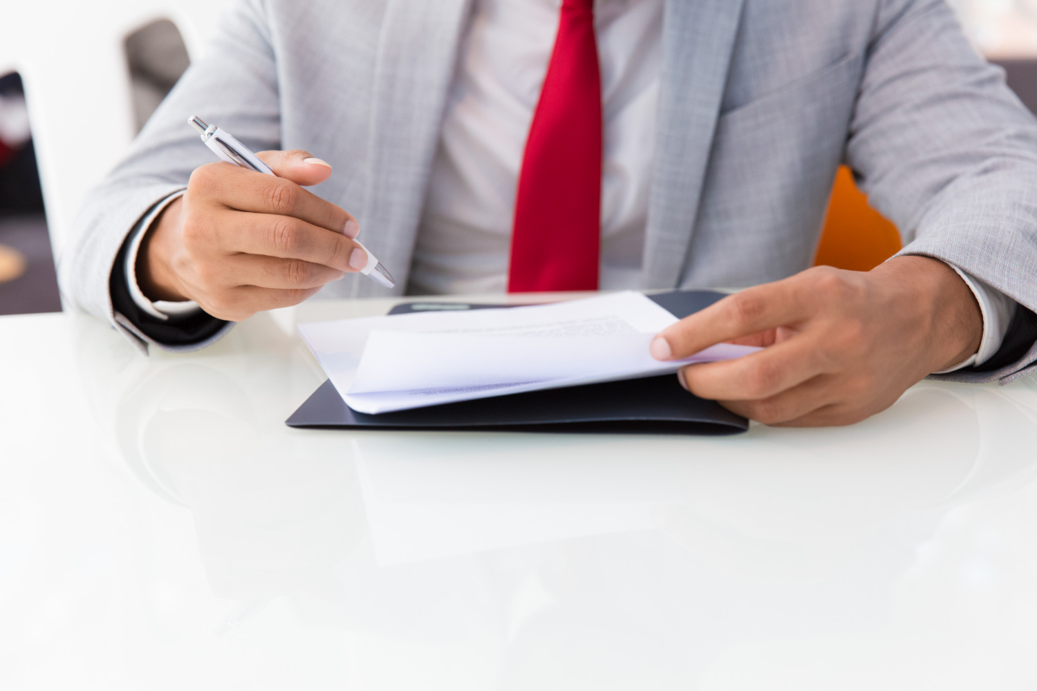 Businessman writing on a document