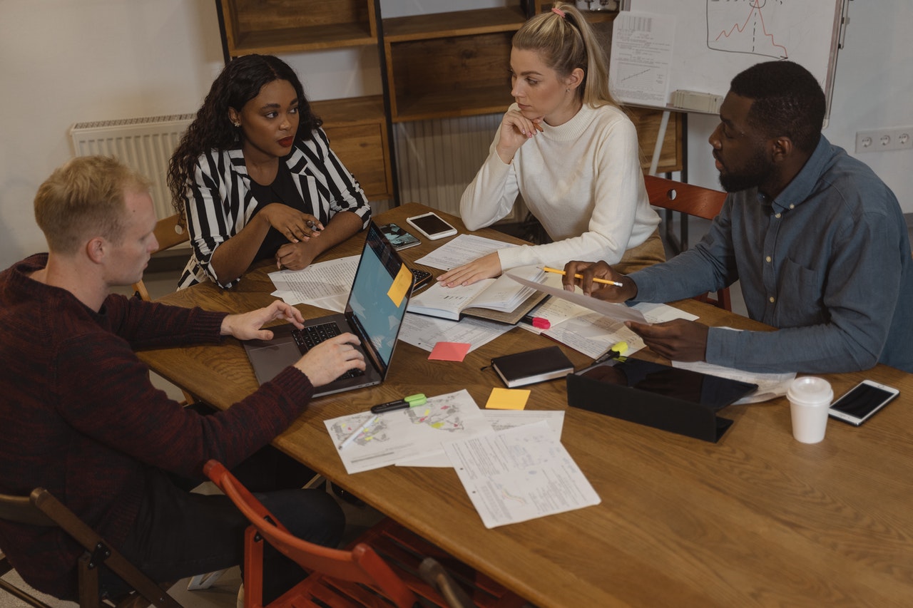 Group of People Discussing at the Table