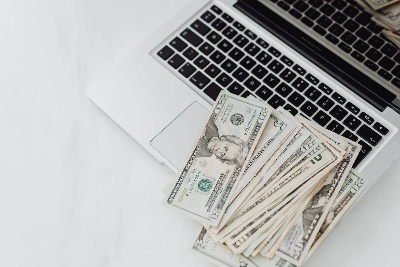 Banknotes on top of a laptop