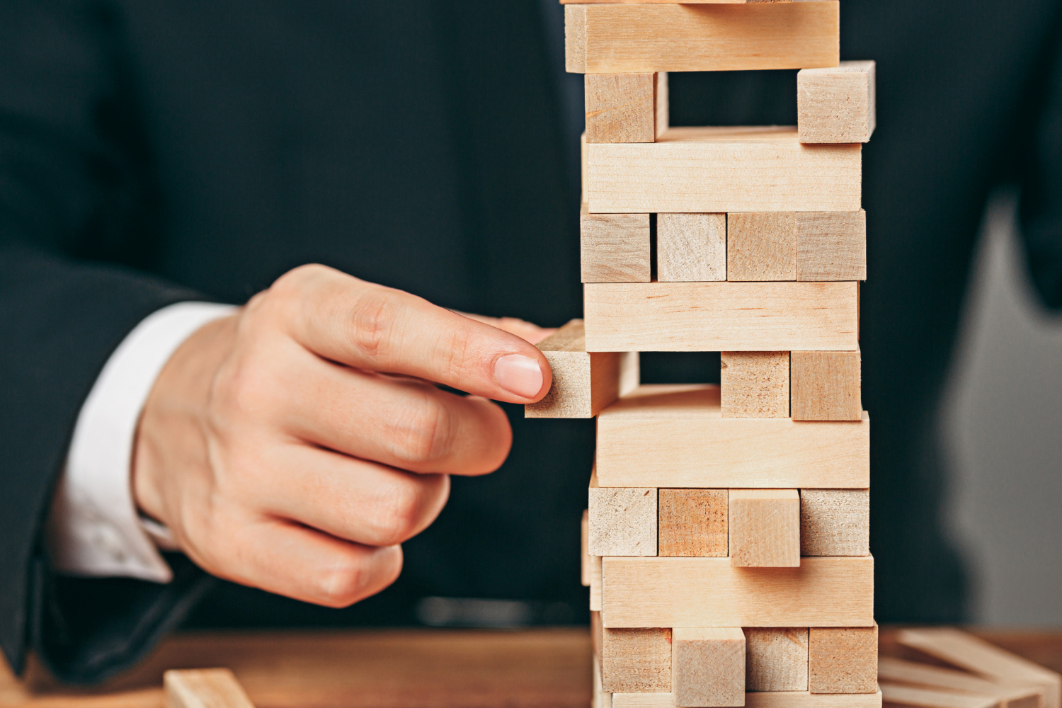 Man arranging wooden cubes