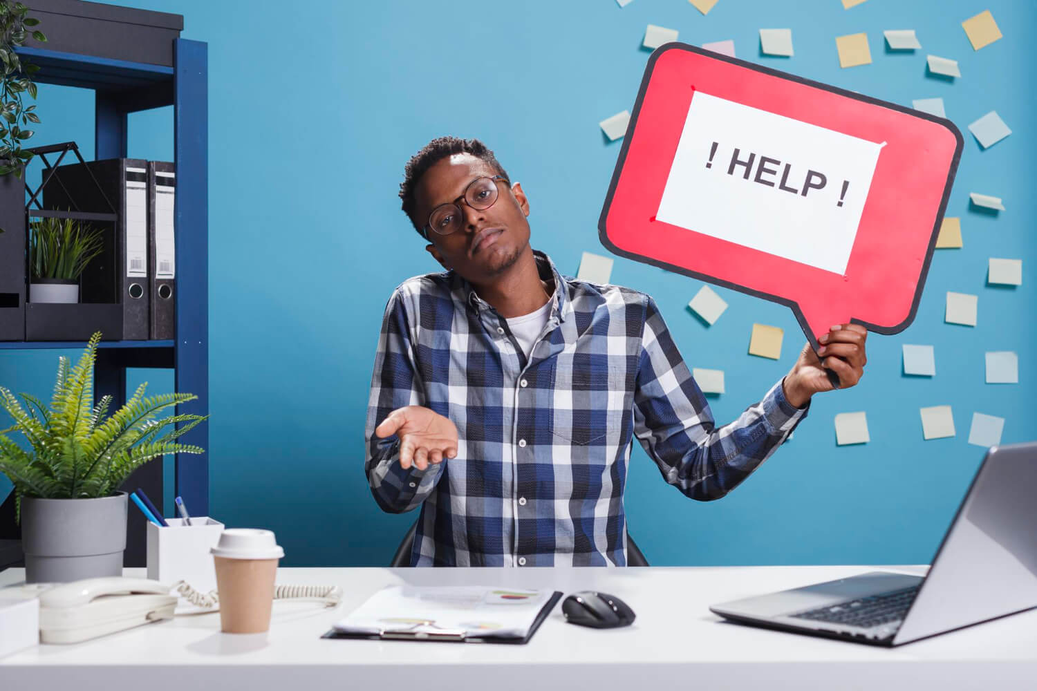 Man holding help cardboard