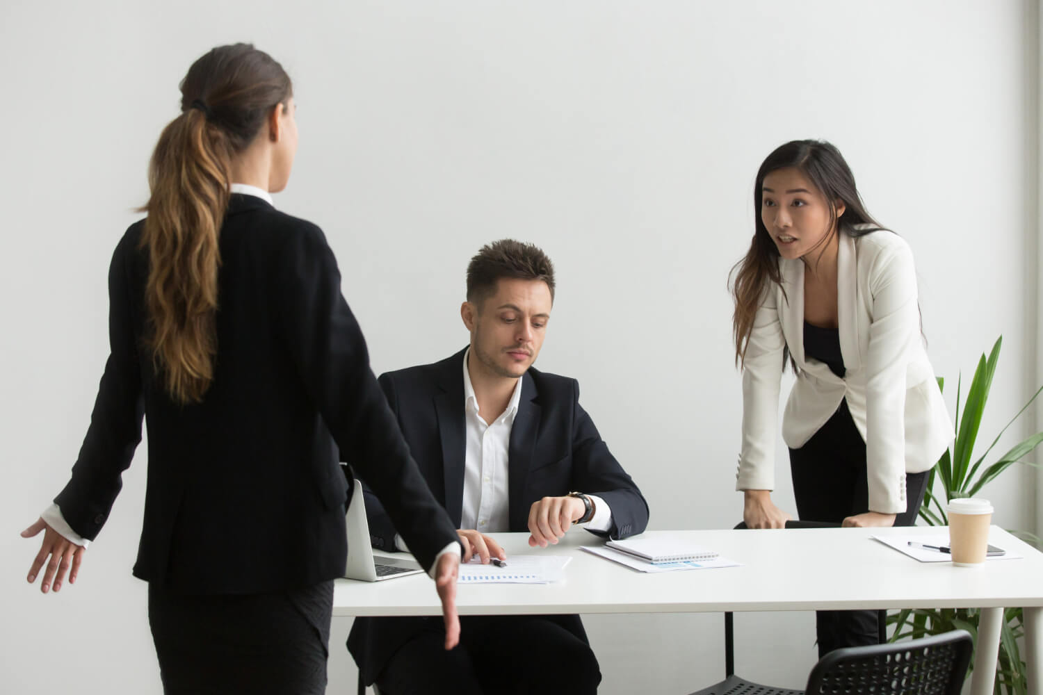 group of workers discussing their manager in a closed space