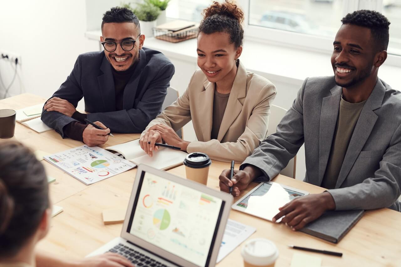 People Smiling While Having a Meeting