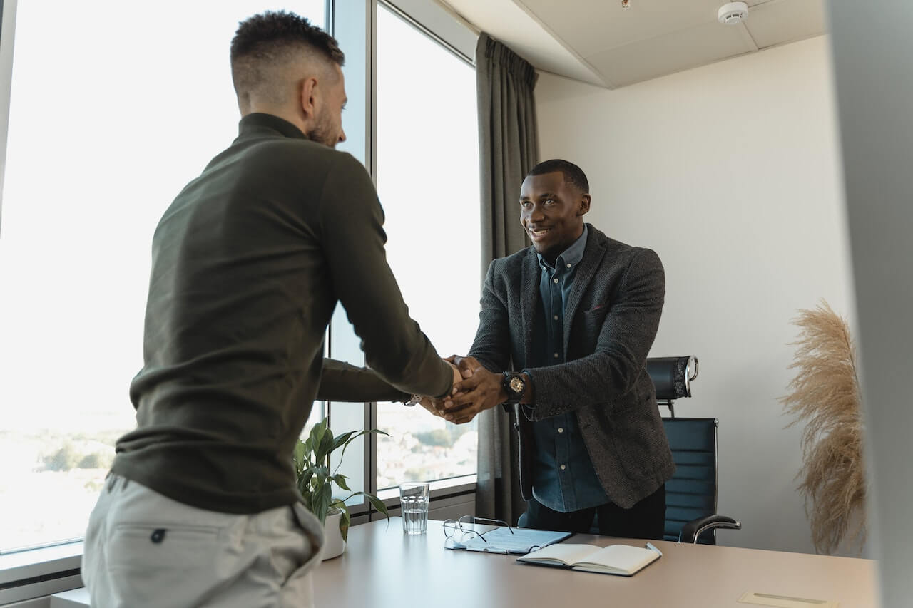 Two men shaking hands after an interview