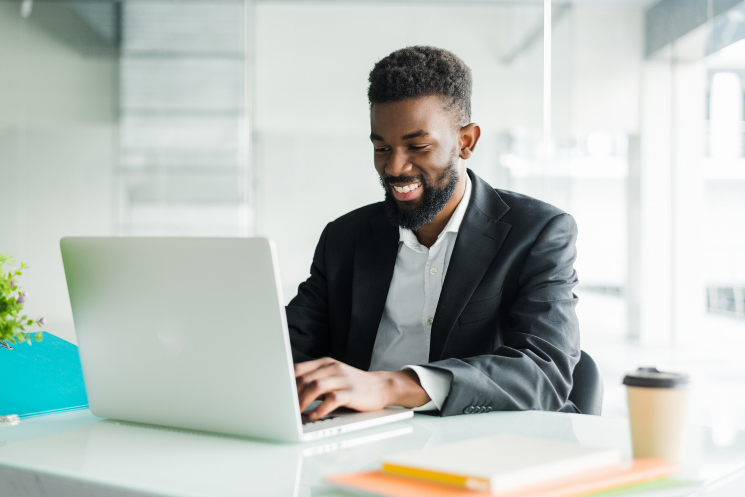 Smiling man working with a laptop