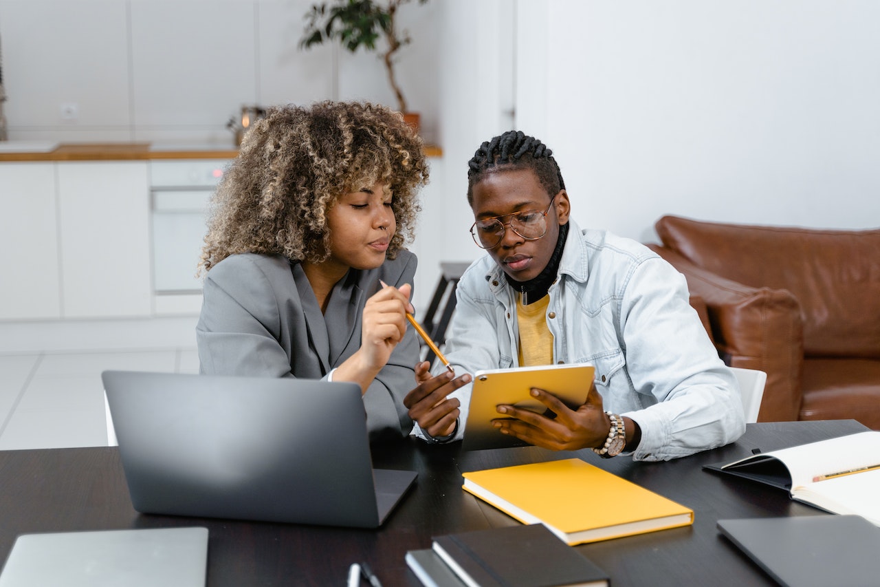 Persons working together in an office using their tab