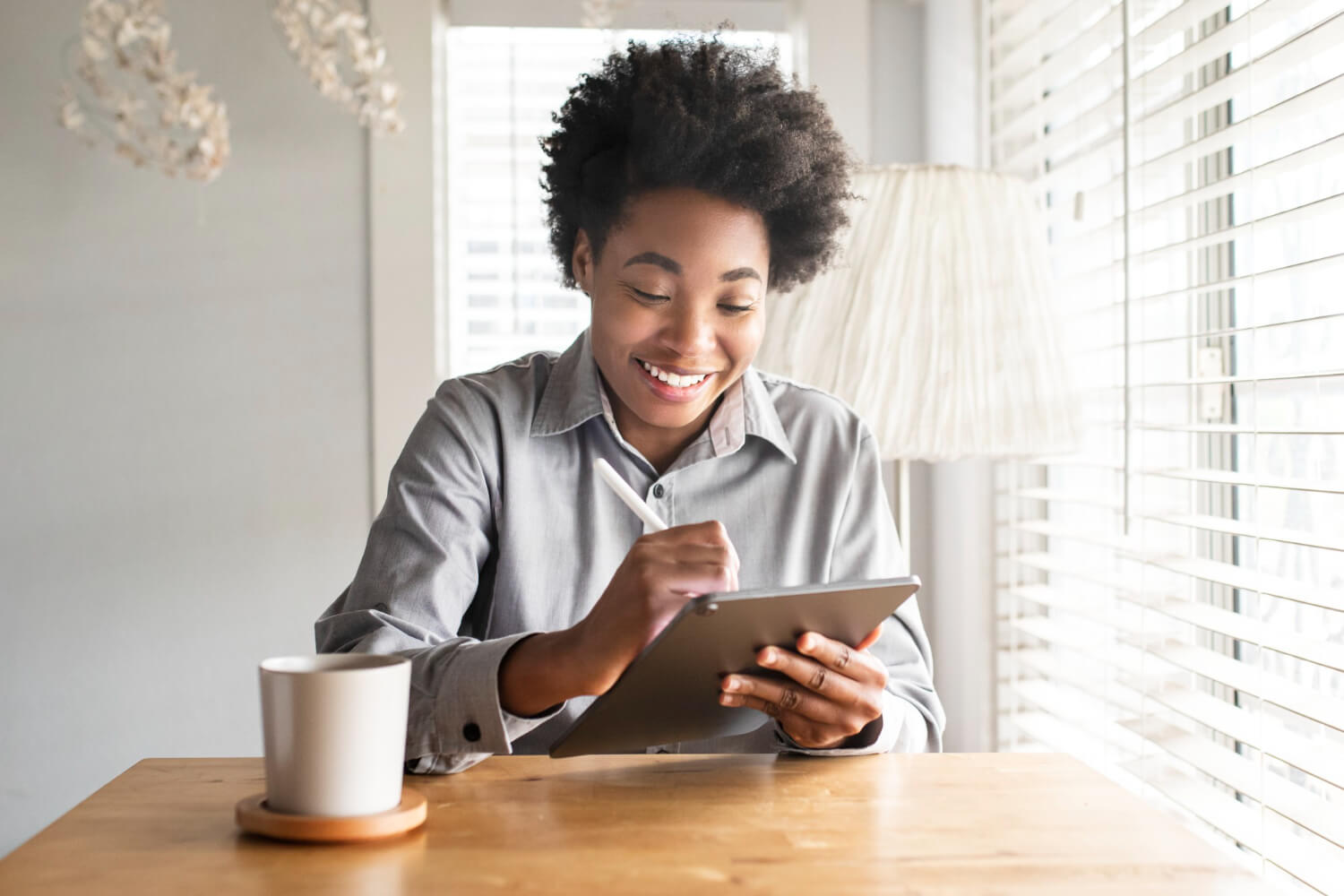 Woman working on a tab smiling