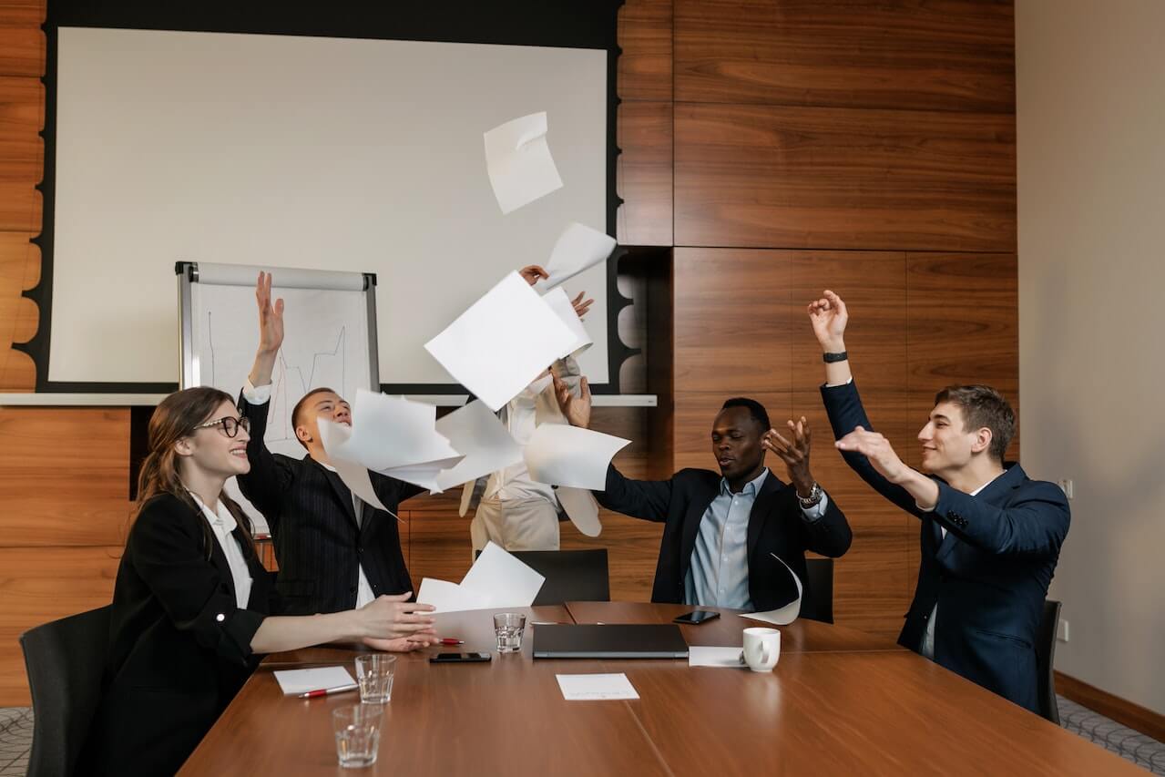 a-group-of-coleagues-jubilating-in-an-office.