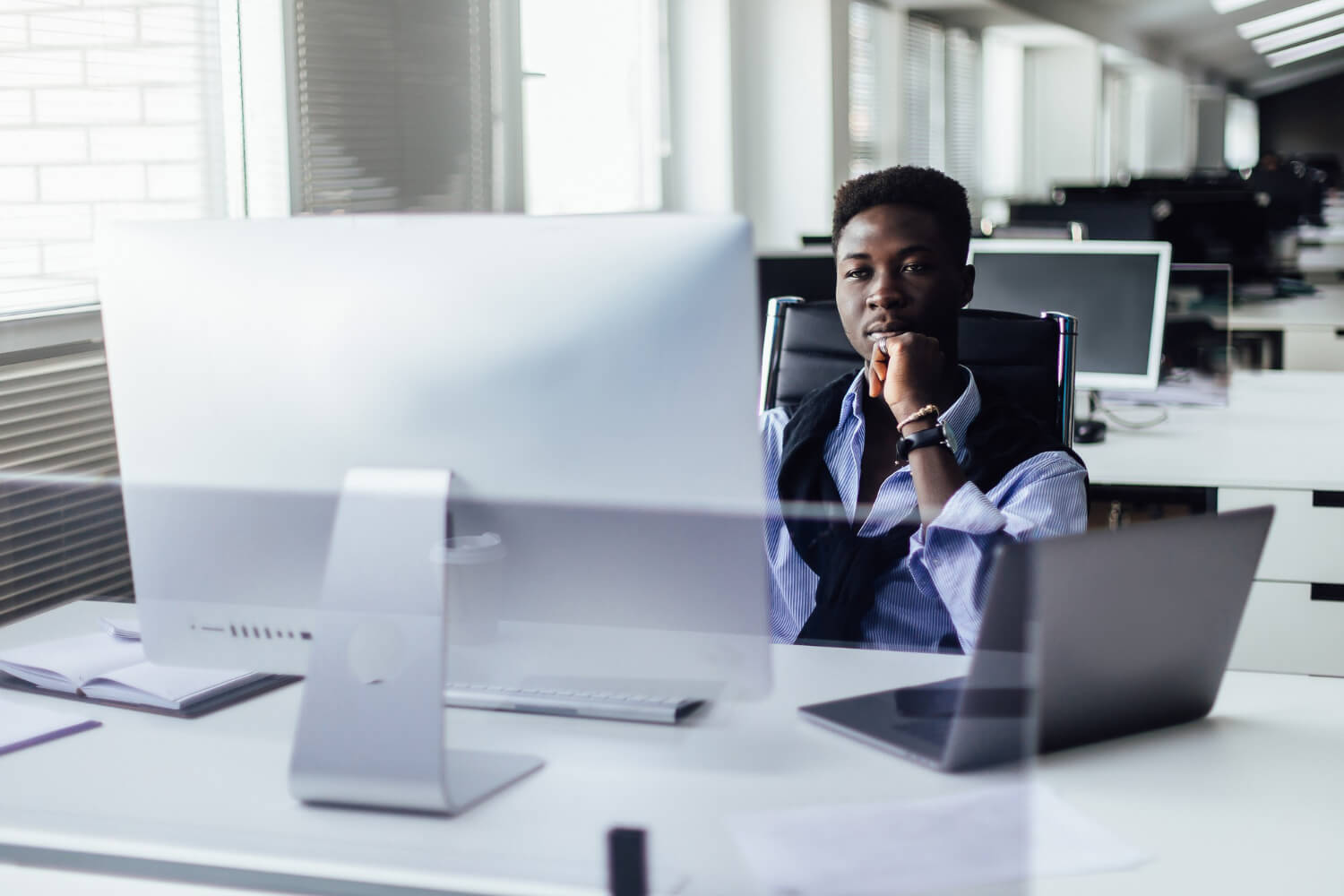 ttractive-hardworking-young-afro-american-office-worker-sitting-desk-front-open-laptop-pc-making-notes-