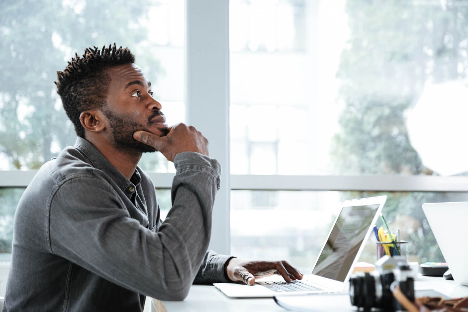 handsome-thinking-serious-young-man-sitting-office-coworking