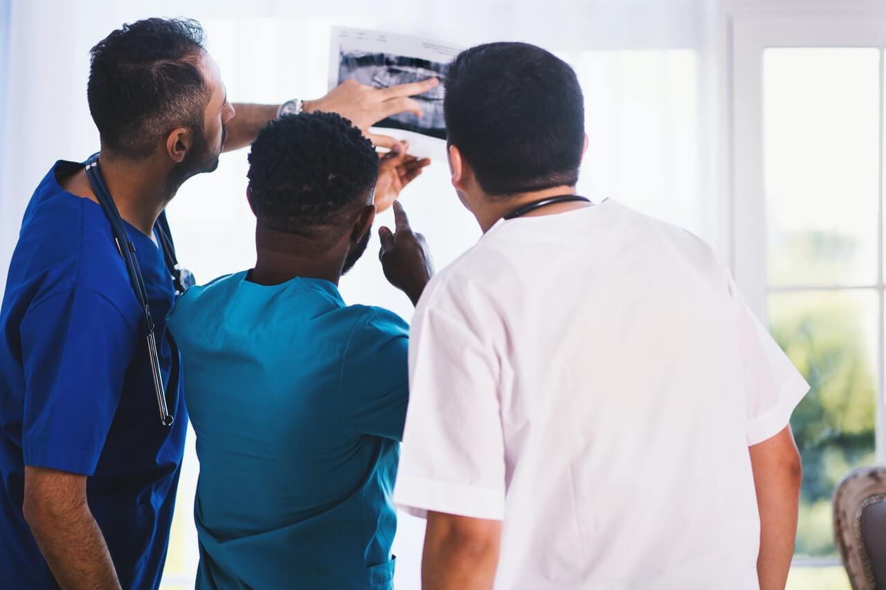 three-medical-practitioners-looking-at-a-medical-result.