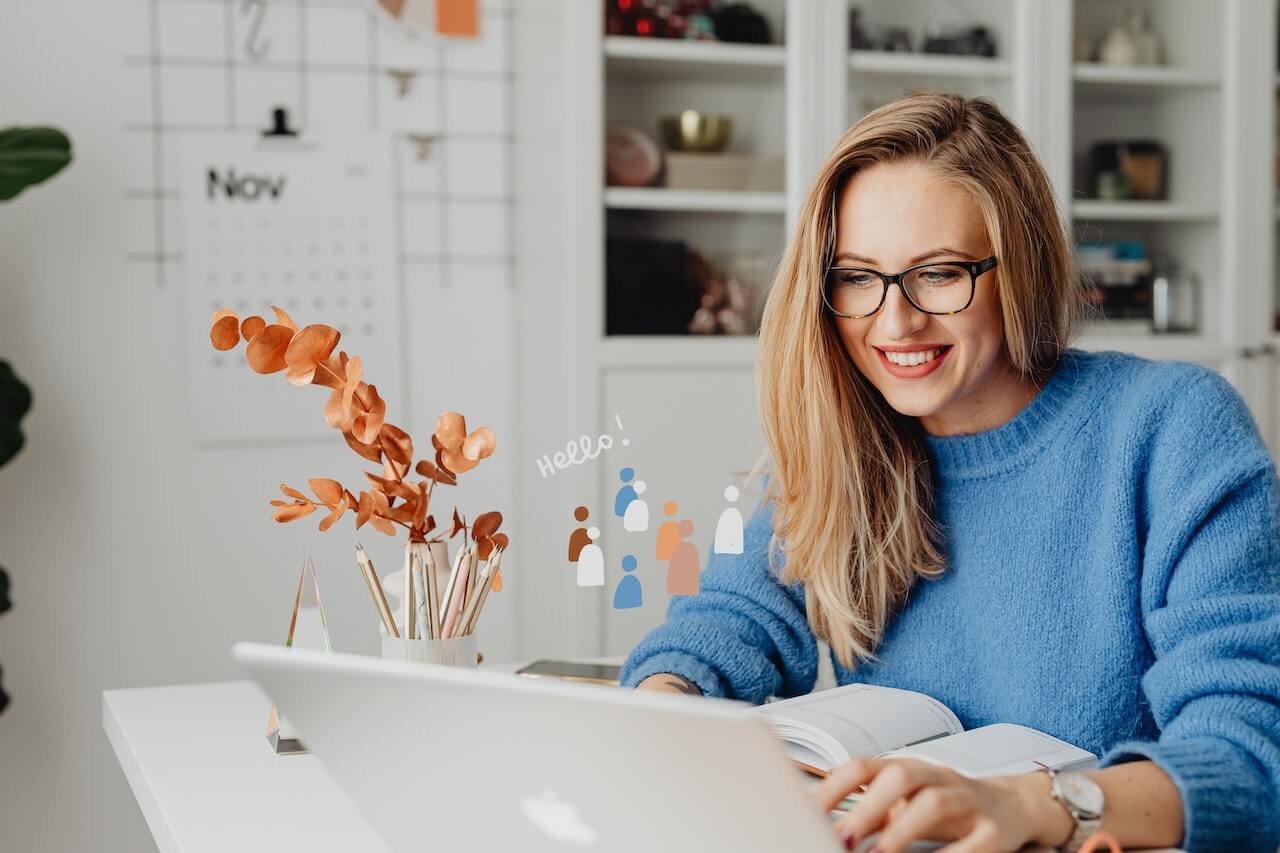 A Woman in Blue Sweater Using a Laptop