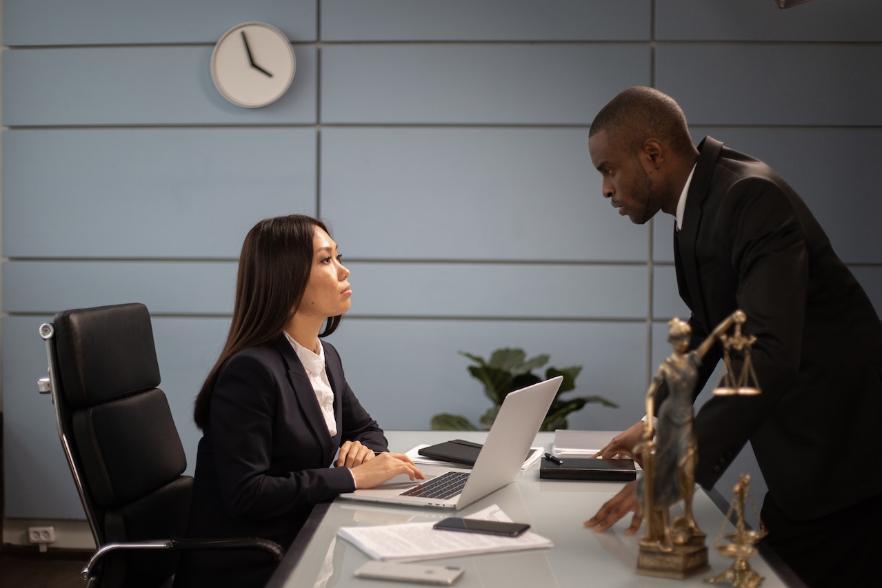 A-business-man-laying-a-complaint-to-a-woman-in-her-office.