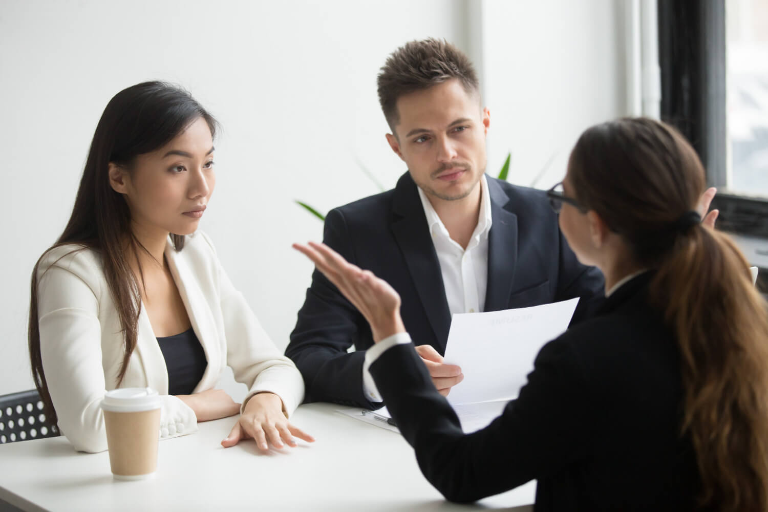 A-female-manager-addressing-two-members-of-her-team