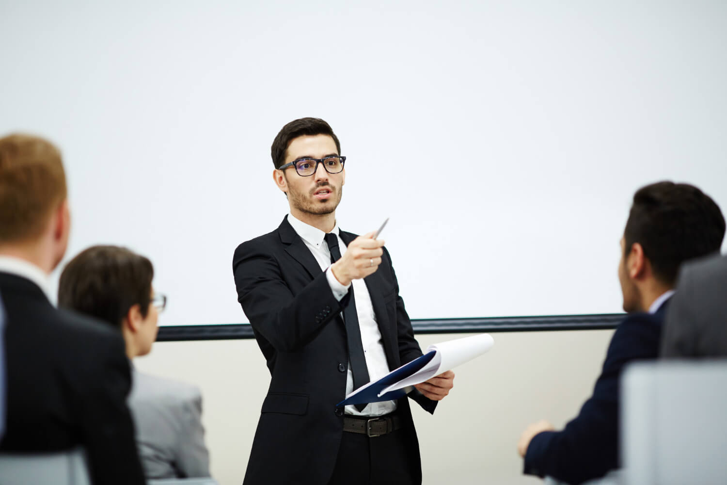 A male leader giving a speech to colleagues in an office