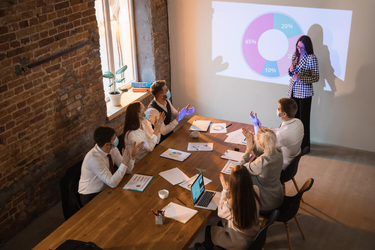 A-speaker-giving-a-presentation-to-a-board-in-a-company